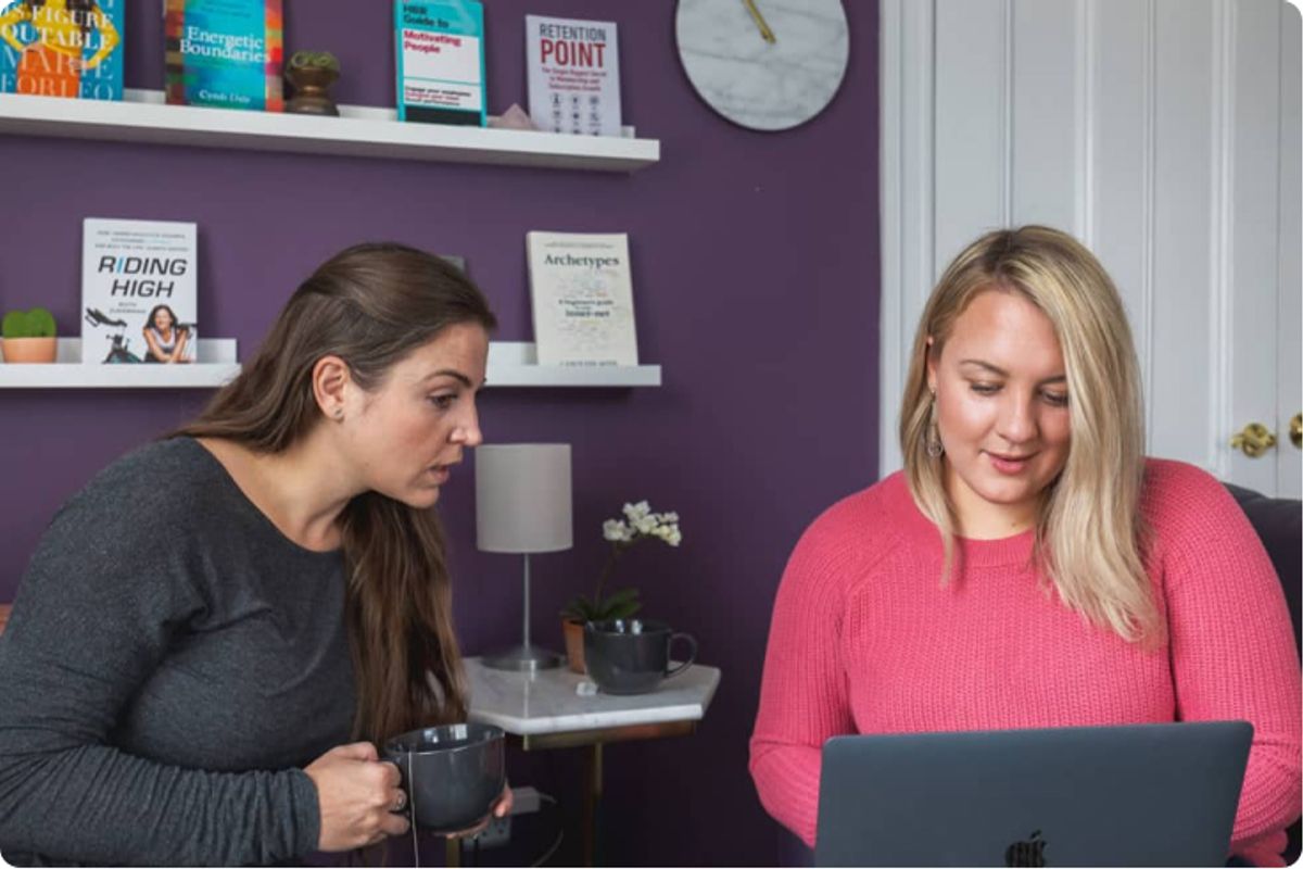 Two women at a computer looking at a business plan